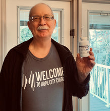 Load image into Gallery viewer, Pure Neuro brain supplement by PureLife Organics – man holding bottle indoors, showcasing daily cognitive support in real-life setting.